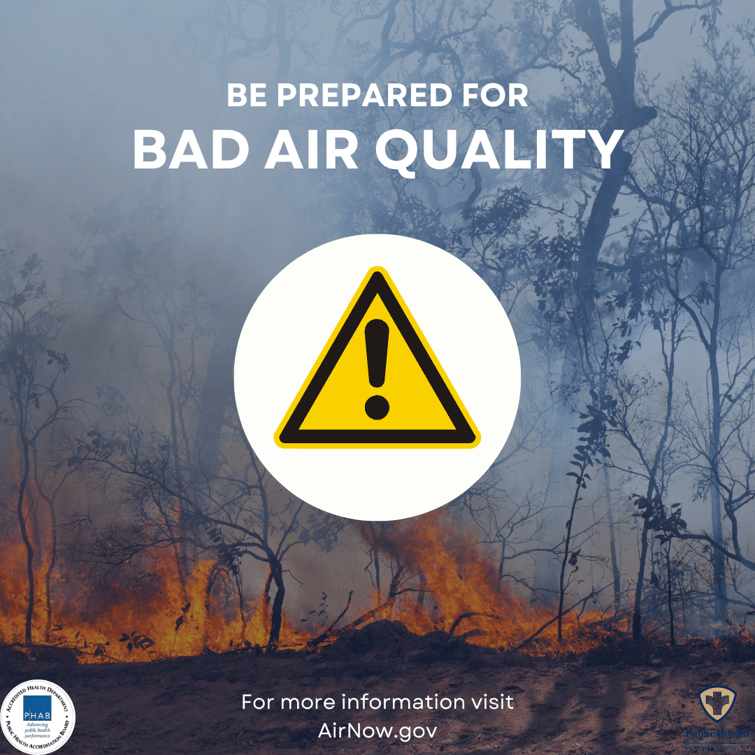 Image of a wildfire in the background with an Air Quality warning in the foreground